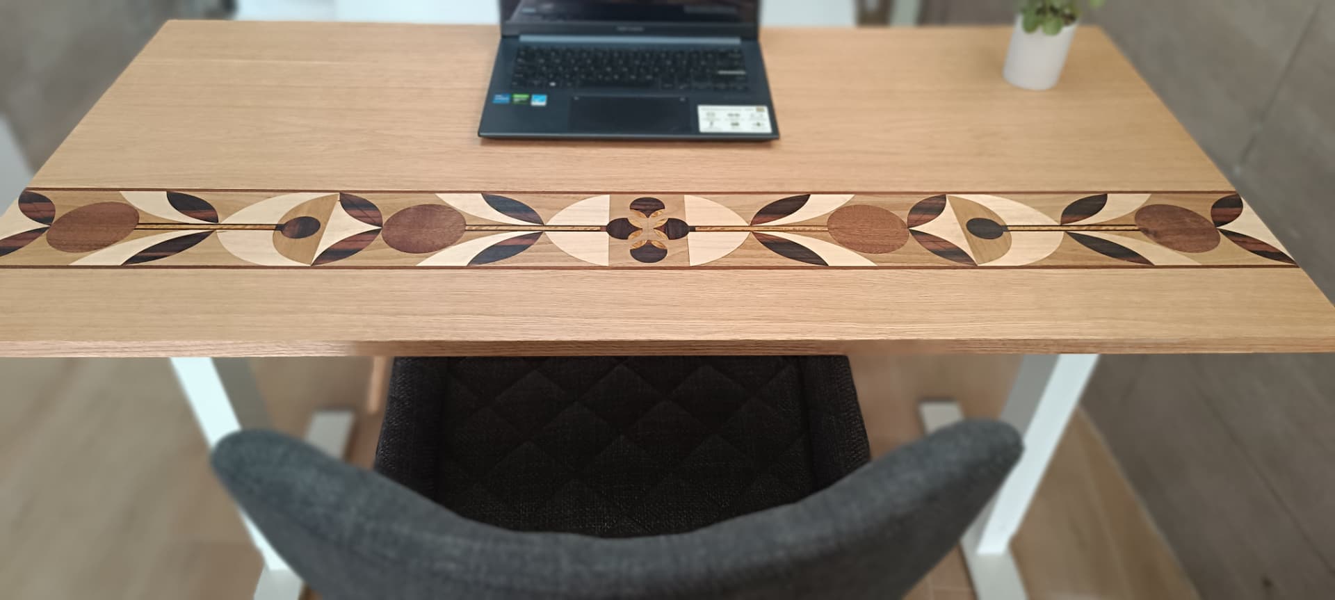 Marquetry desktop with a laptop in a professional workspace