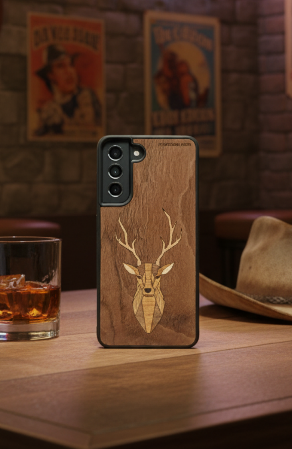 Wooden phone case with deer design on a wooden table in a rustic, texas-style setting